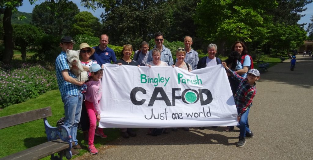group of people in front of CAFOD banner