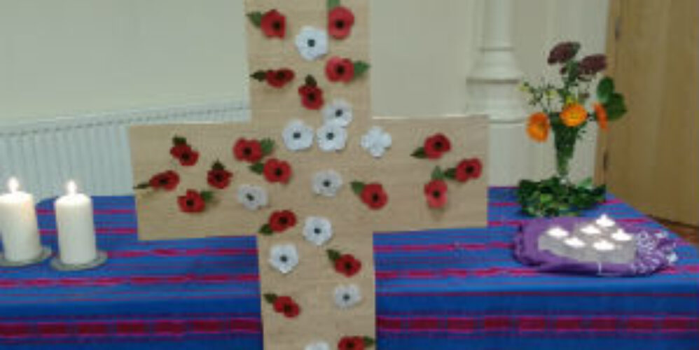 red and white poppies on a cross