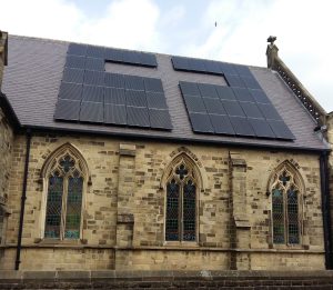 solar panels on a church roof giving the shape of a cross