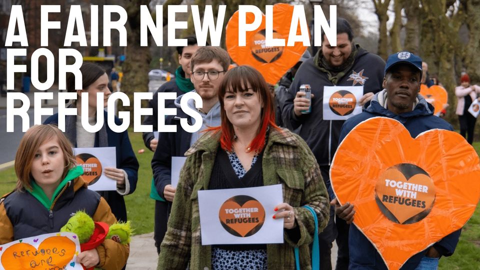 A fair new plan for refugees - photo of a group of people holding placards and banners