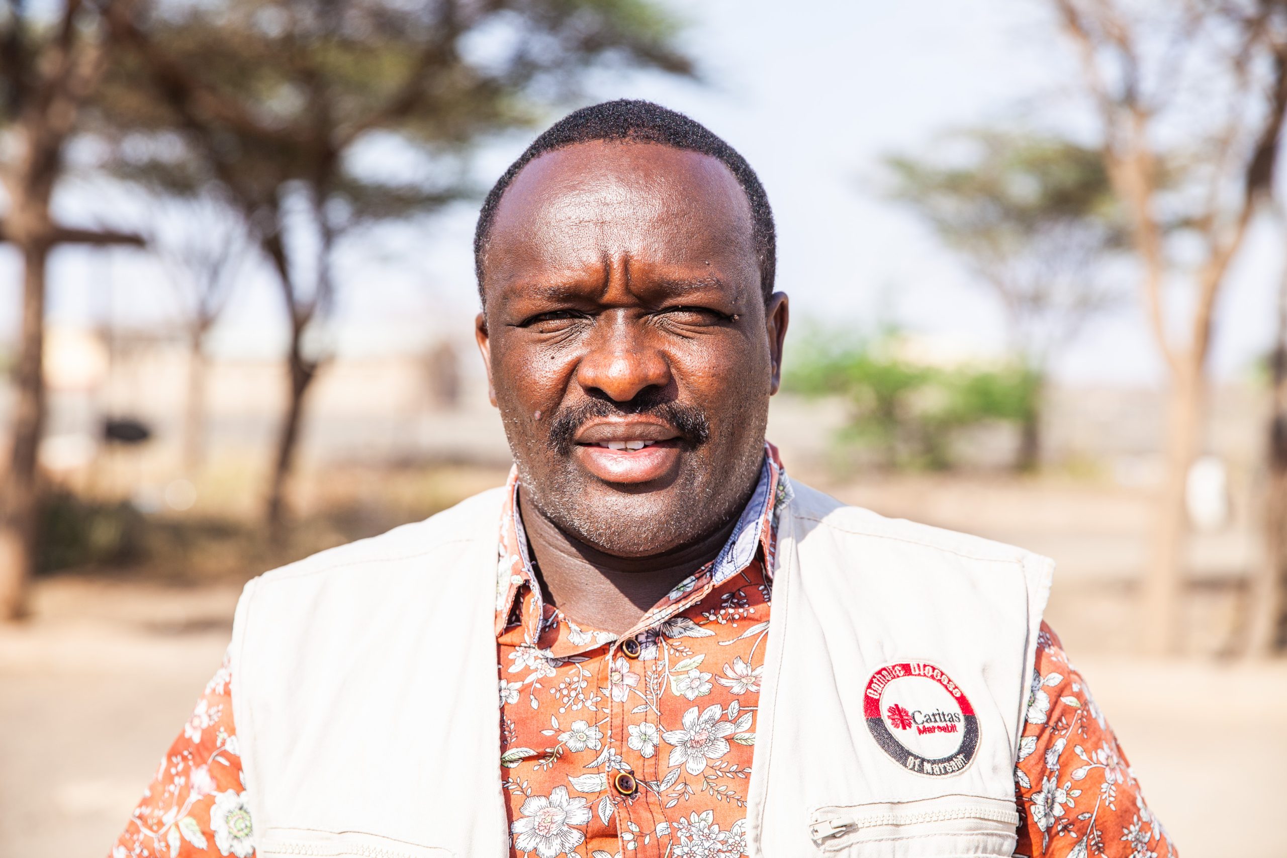 Bante-Galgallo-works-as-Emergency-Response-Manager-for-Caritas-Marsabit. Bante with trees in the background