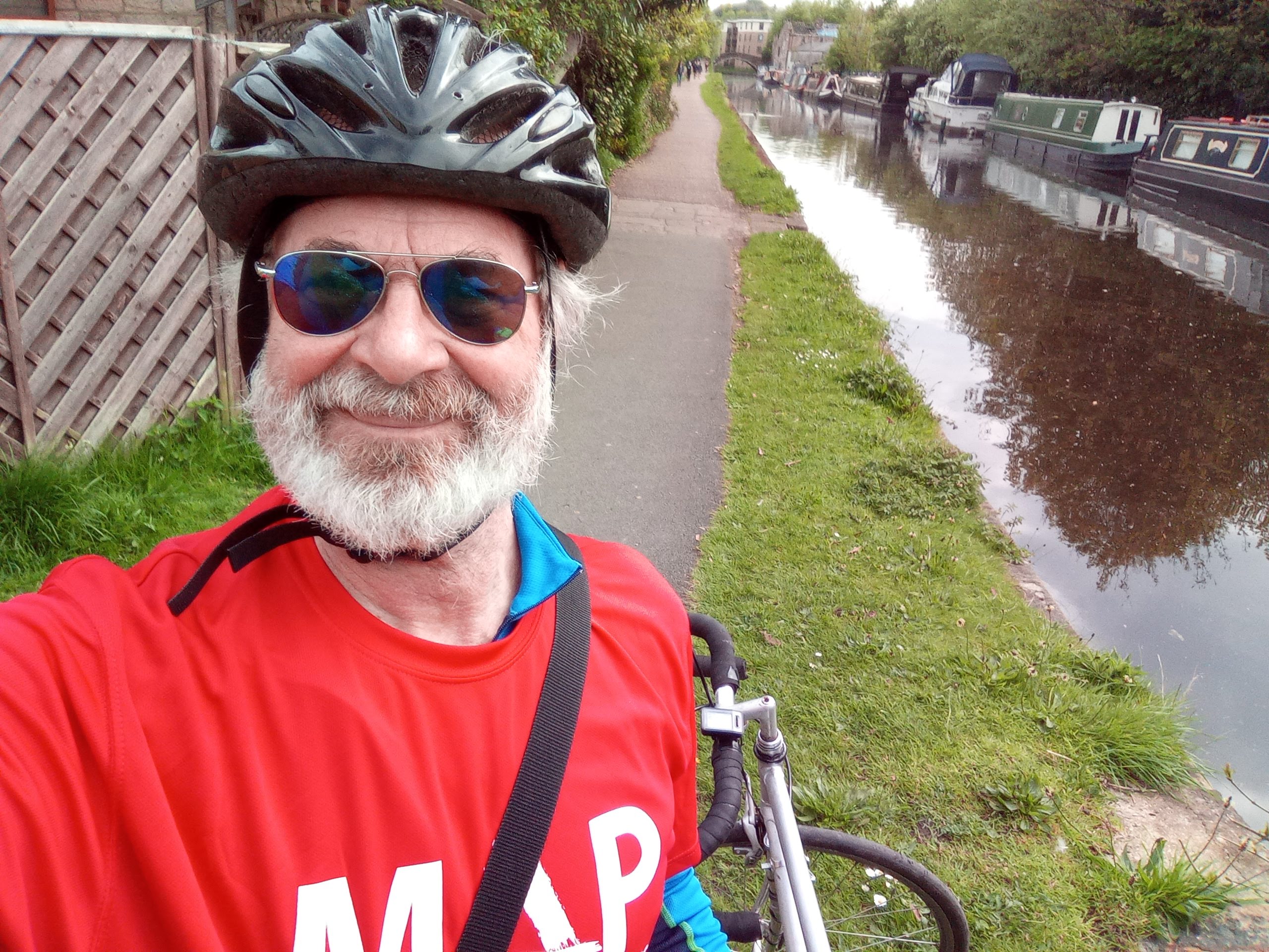 Tim wearing a cycle helmet on a towpath