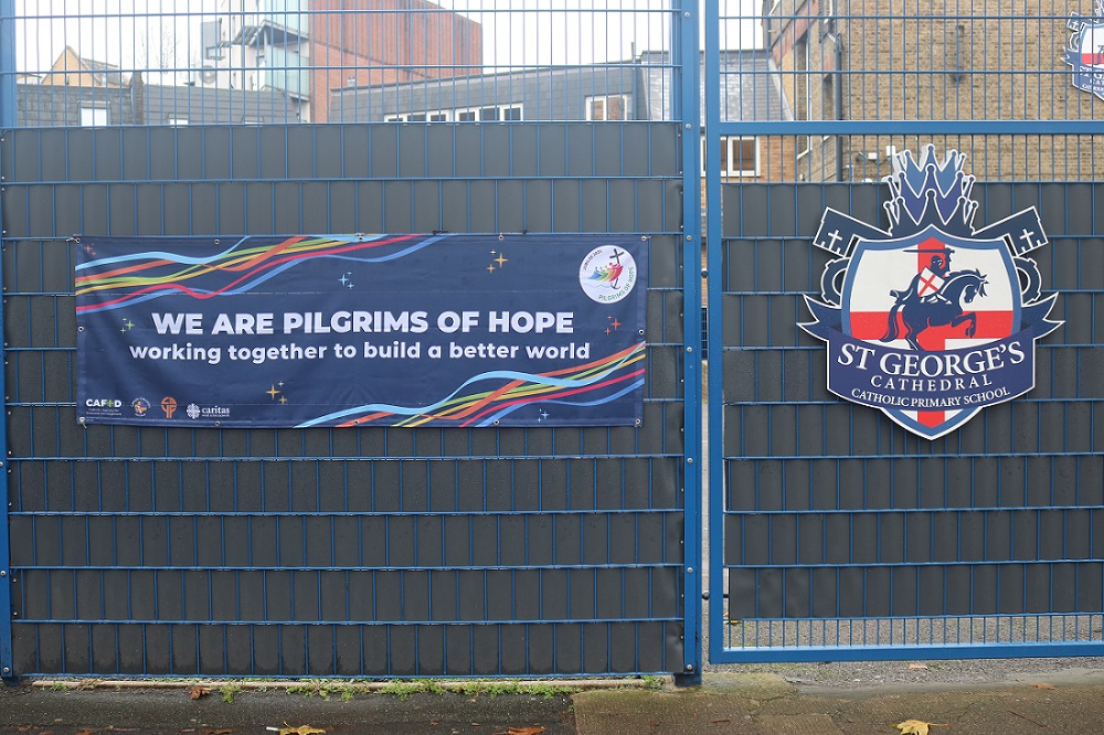 Pilgrims of hope banner attached to school fence